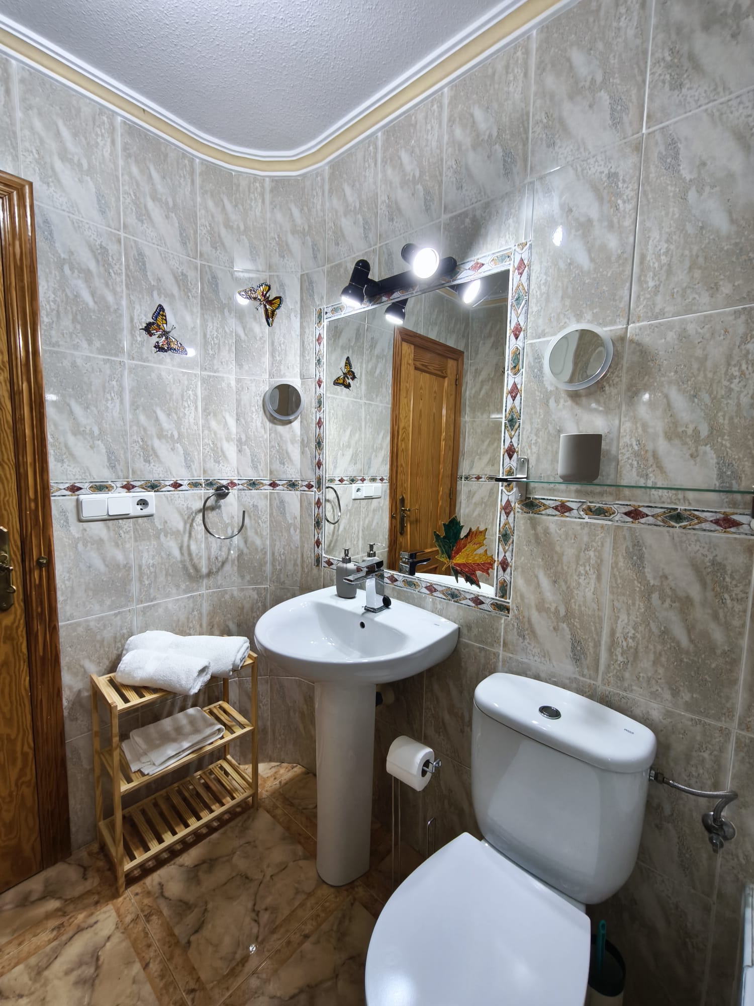 Bathroom with decorative mirror and towels